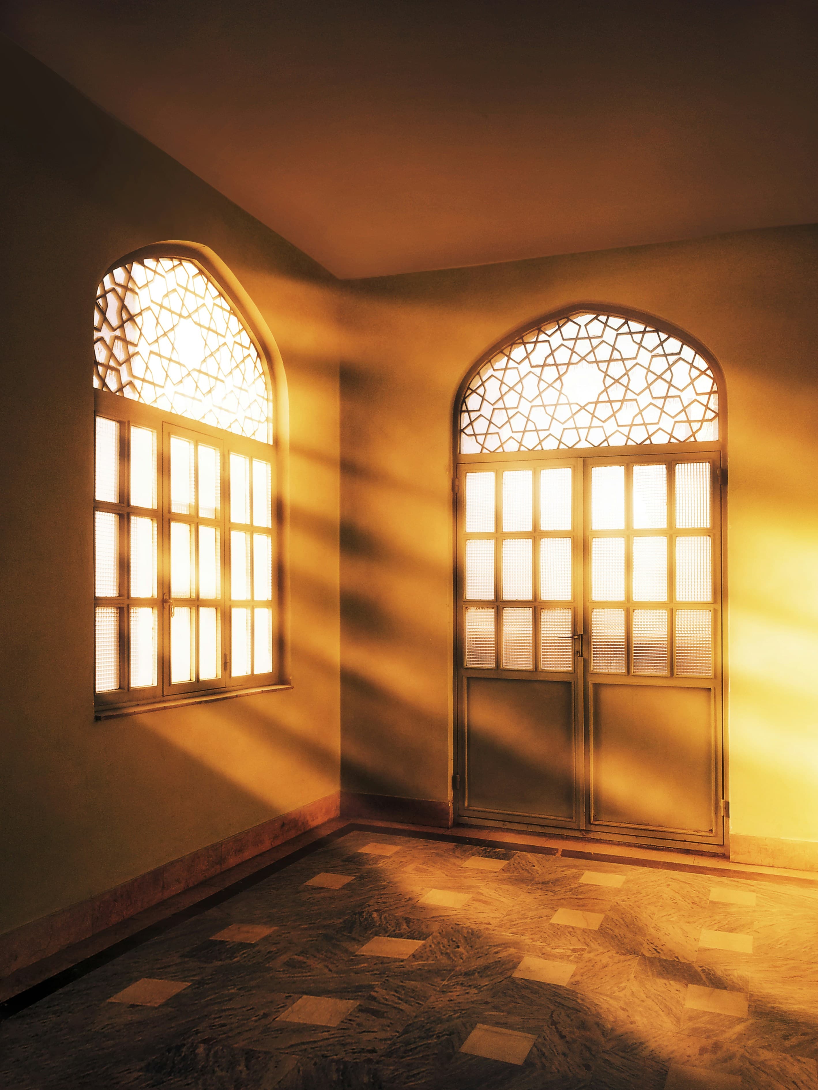 Morning light through the arched windows of a masjid